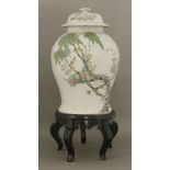 A Jar and Cover, early 20th century, the baluster body painted with two canaries in flowering