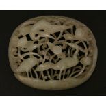 A carved and pierced jade Appliqué,Yuan/Ming (13th/14th century), of oval, domed form with two