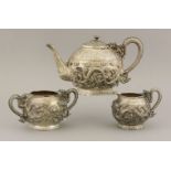 A silver three-piece Tea Set, c.1900, of circular form on a circular foot with ruyi head clouds,