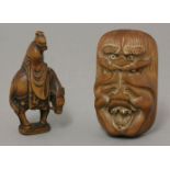 A wood Netsuke,an hilariously laughing mask, topped by a shishi, its eyes inlaid in mother-of-