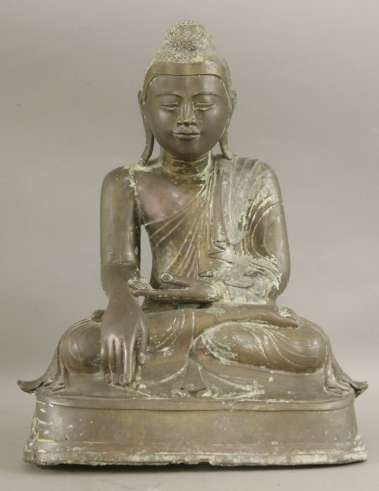 A bronze Buddha,19th century, seated in Bhumisparsa mudra on a stepped platform,44cm