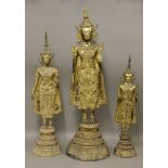 Three Thai gilt bronze Buddhas,19th century or later, all in elaborate robes and decorative hair