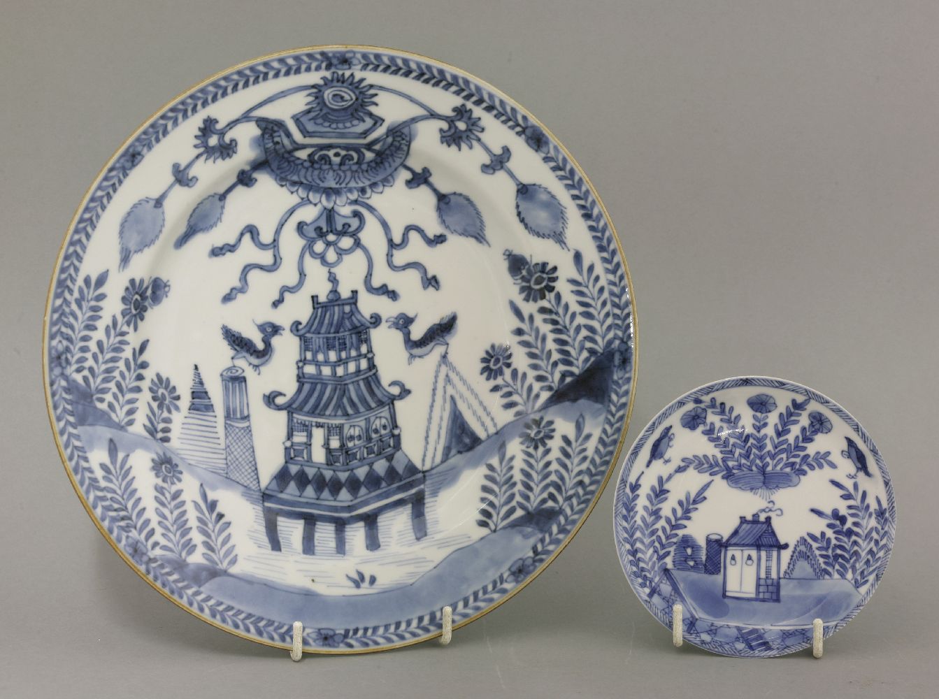 A rare blue and white Plate, mid 18th century, painted with two birds flanking a pagoda below