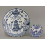 A rare blue and white Plate, mid 18th century, painted with two birds flanking a pagoda below