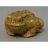 A gilt wood toad, 20th century, naturalistically carved with inlaid eyes, 5cm; and a hardwood