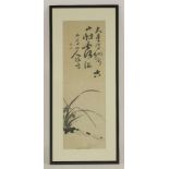 A hanging scroll of calligraphy, with a poem and orchid to the lower section, signed and with two