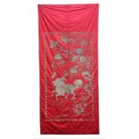 A large silk Wall Hanging, late 19th century, embroidered in gold thread with a qilin carrying a