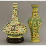 Two vases, 19th century, a bottle vase with dragons on a yellow ground, 29cm, wood stand, and a