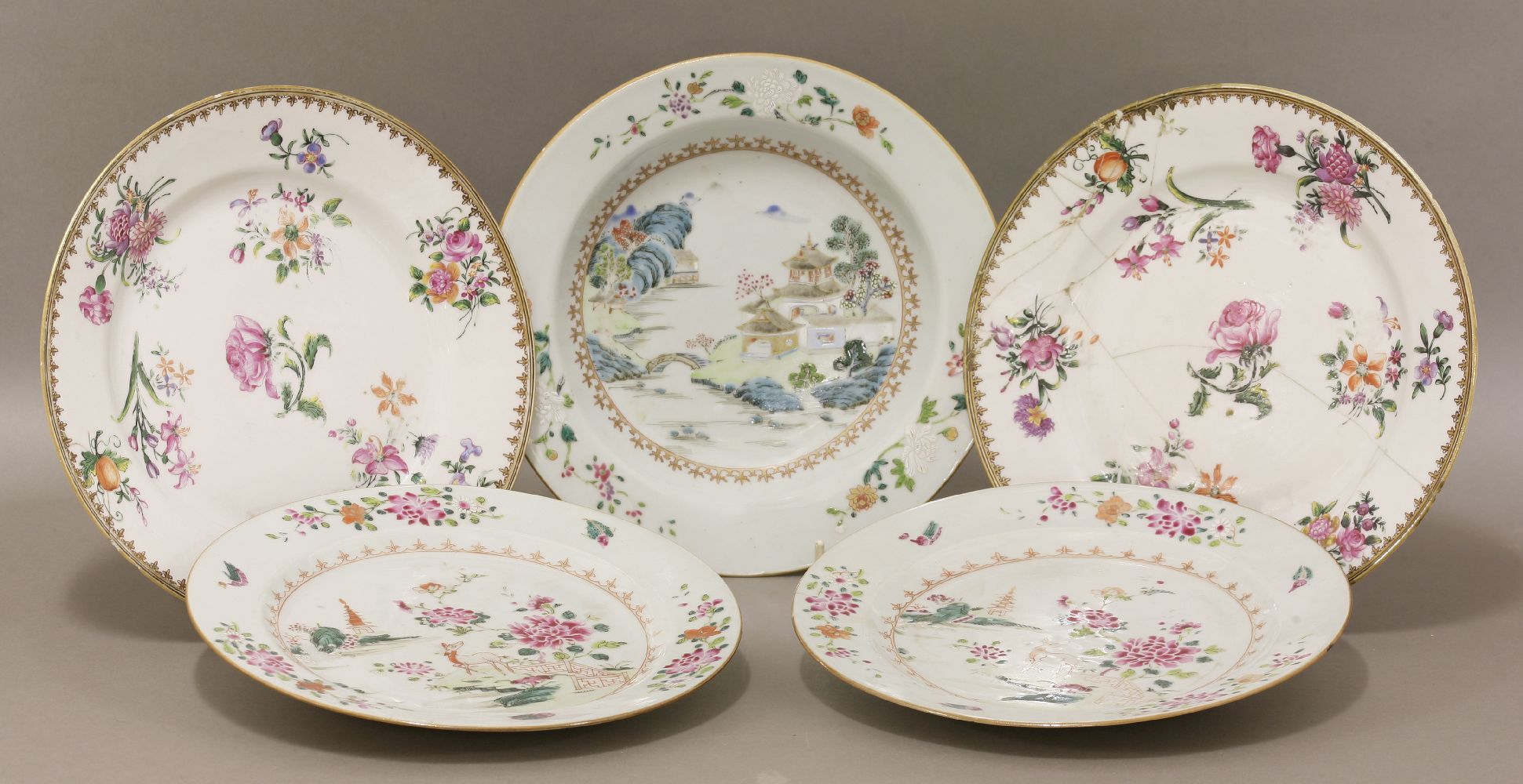 Five various porcelain famille rose Plates,18th century, four with floral design and one with houses