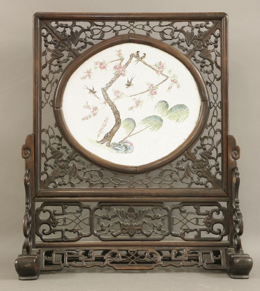 A porcelain Table Screen,Guangxu (1875-1908), the oval panel painted with swallows on a gnarled