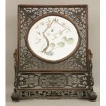 A porcelain Table Screen,Guangxu (1875-1908), the oval panel painted with swallows on a gnarled