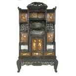 A carved blackwood Display Cabinet,c.1870, with ho-o pediment above a series of apertures with