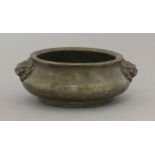 A bronze Censer,late Qing dynasty, the squat body with a slightly flared rim, Buddhist lion handles,