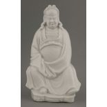 A blanc de Chine Figure,18th century, of a seated dignitary wearing long flowing robes and elaborate