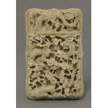 A deeply carved ivory Card Case,mid-19th century, the top side with dragons amongst clouds and