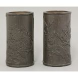 A pair of bamboo brush pots, 19th century or later, carved with either chrysanthemums or prunus, the
