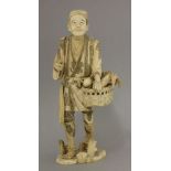 A sectional walrus ivory Gardener,late 19th century, the man wearing engraved tunic holding a