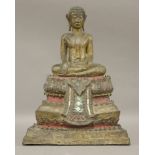 A gilt bronze Buddha, 19th century or later, seated in Bhumisparsa mudra on a stepped gilded and red