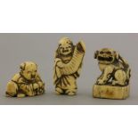 Three ivory Netsuke,various dates, a boy making bekkako with a mask and laughing, a wildman with