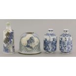 Three blue and white snuff bottles, 20th century, one cylindrical with buildings, rocks and trees,