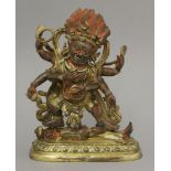 A gilt bronze figure of Mahakala, 20th century, the Dharma protector with flaming hair standing on