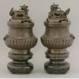 A rare pair of bronze Temple Incense Burners and Covers,Qianlong, dated on the shoulder to