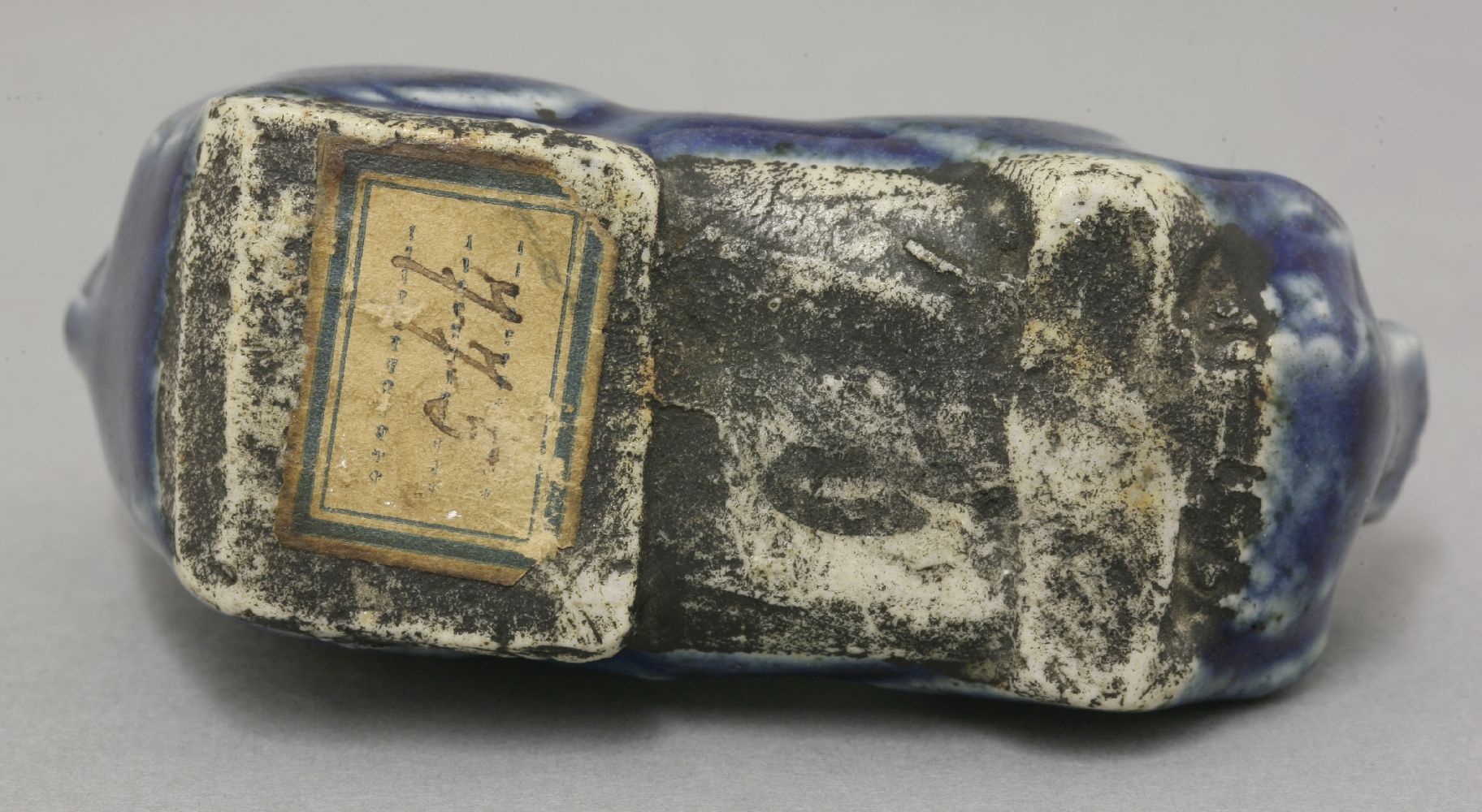 A porcelain blue glaze Water Dropper,18th century, in the form of a reclining Buddhist lion, the - Image 3 of 3