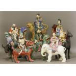 A set of eight enamelled and gilt biscuit porcelain Daoist immortals, 20th century, each