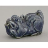 A porcelain blue glaze Water Dropper,18th century, in the form of a reclining Buddhist lion, the