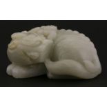 A jade Weight,late Ming/early Qing, in the form of a kylin, its head turned to the rear and with