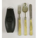 A campaign set comprising a silver-plated spoon, fork and steel knife with folding ivory handles,the