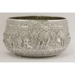 A Thai silver bowl,decorated in relief with pictorial scenes of the Jataka, with a floral frieze