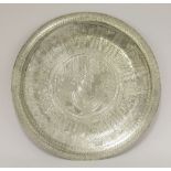 An Egyptian silver dish,of shallow shaped circular form, engraved with Egyptian revival decoration