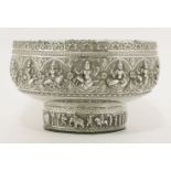 A silver bowl,probably Burmese,of circular form on circular foot, decorated with dancing figures and