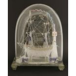 A Victorian 'Nailsea' glass sailing ship, under a glass dome, with two subsidiary ships and a