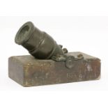 An unusual model bronze siege mortar,on a wooden stand,21.5cm long, 4cm bore