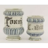 A maiolica dry drug jar,early 16th century, with a central band inscribed in Lombardic characters