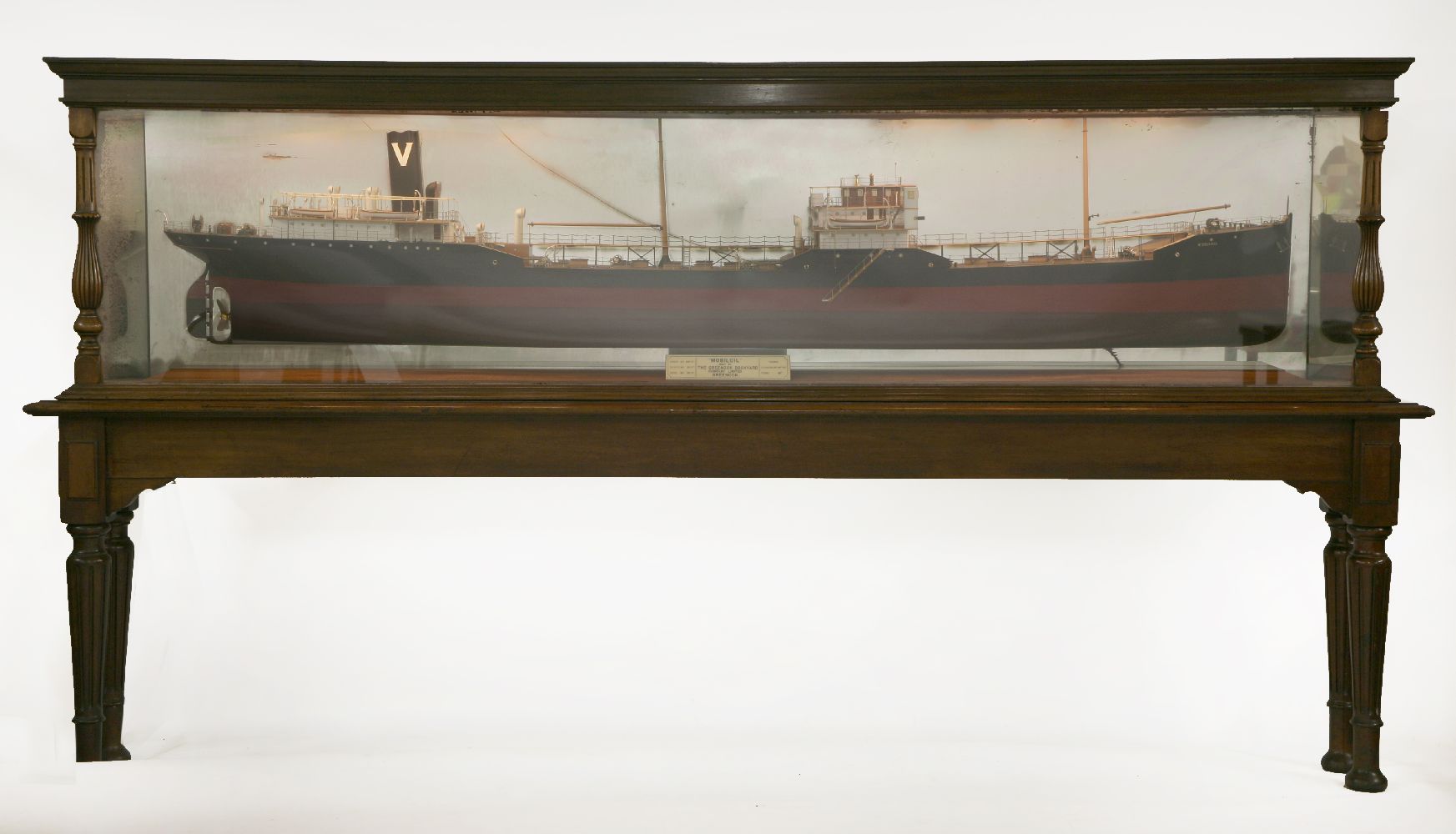 A mahogany cased half ship model 'Mobiloil',with a mirror back, cracked, labelled 'Mobiloil', with