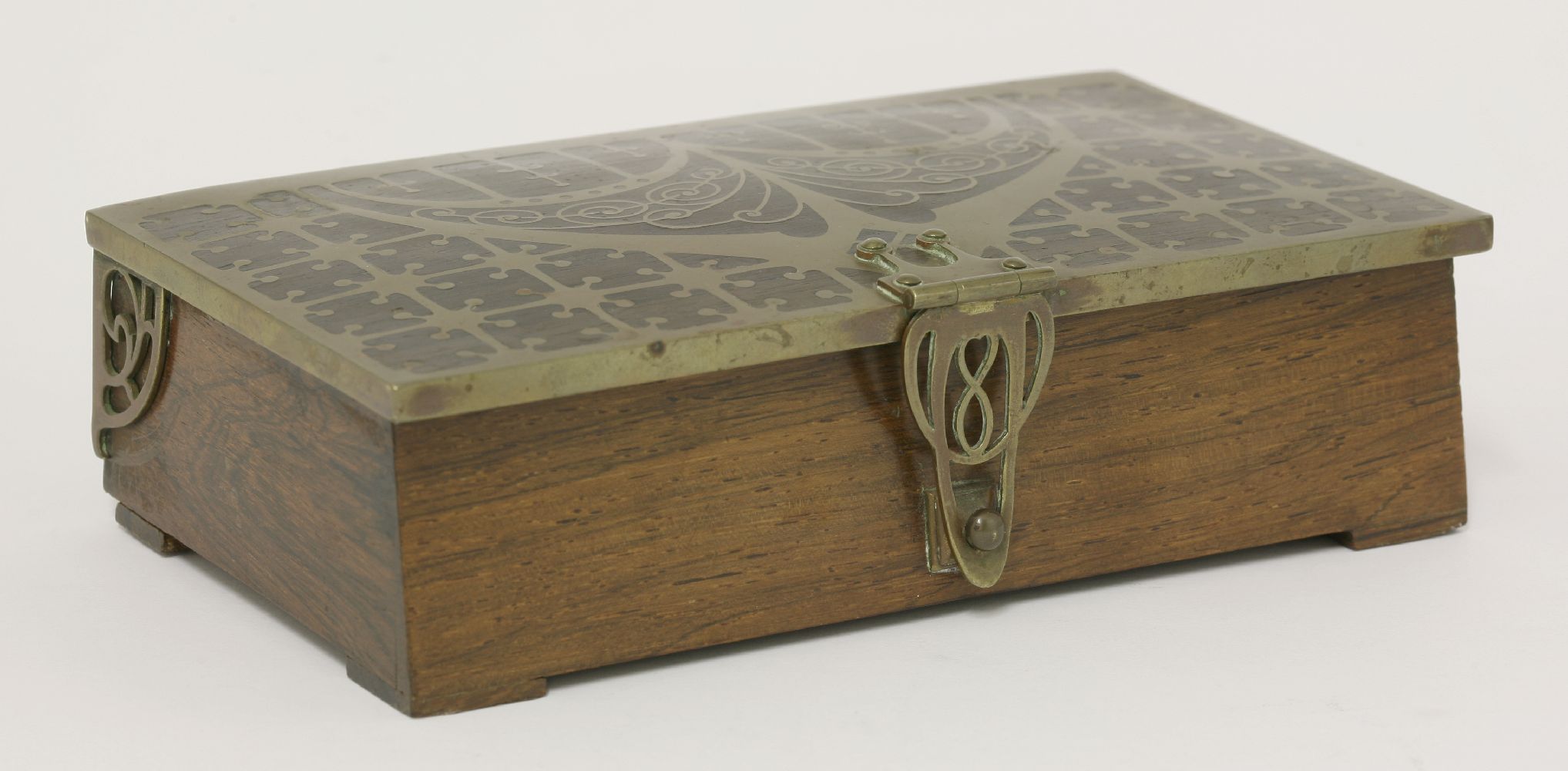 A French Art Nouveau rosewood casket,early 20th century, the cover with ornate brass inlay and