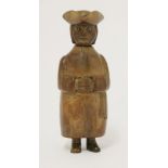 A yew wood cleric snuff box,18th century, modelled wearing a tricorn hat, glass eyes, his hands