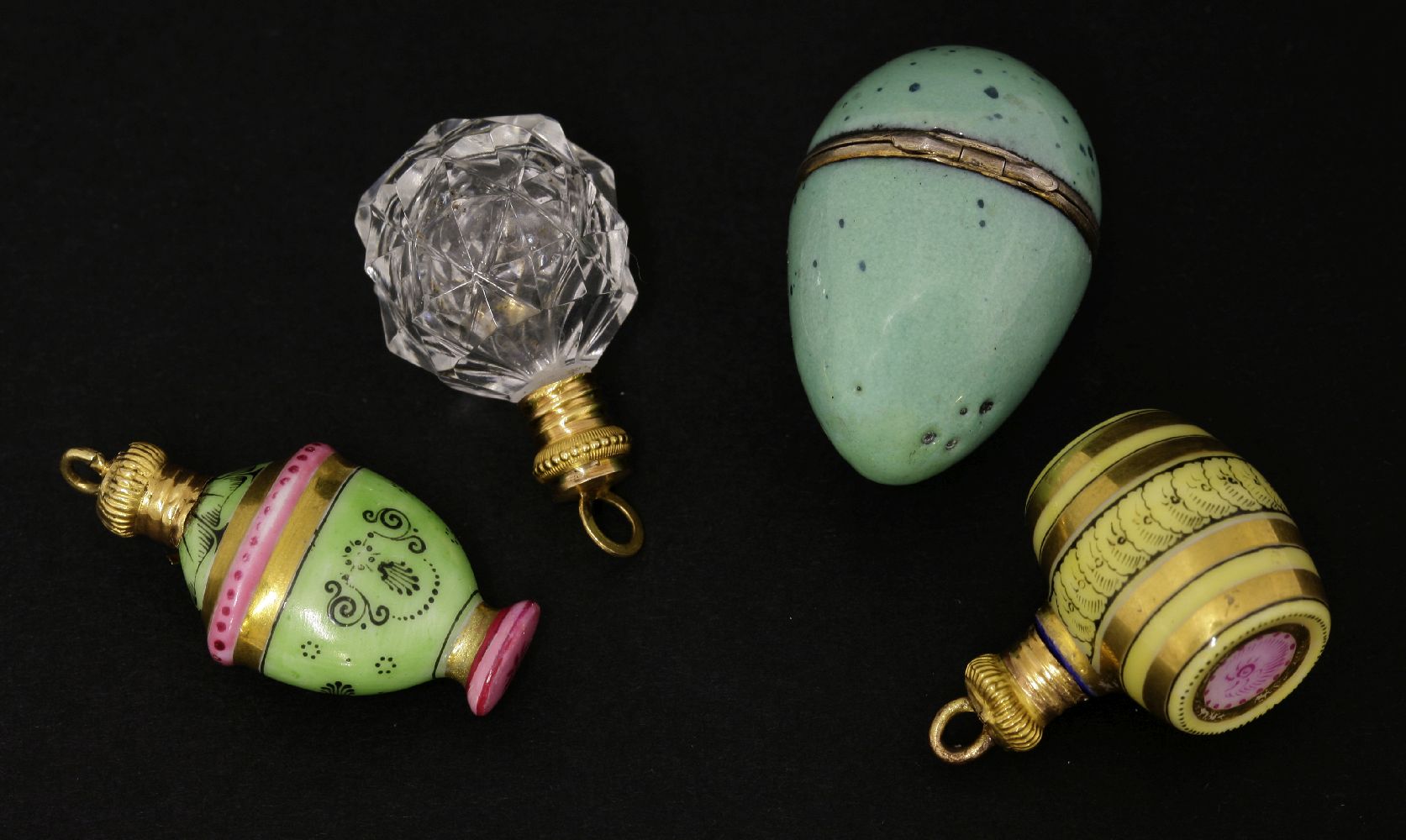 A group of four scent bottles, comprisinga porcelain thrush's egg, with silver gilt mounts and glass