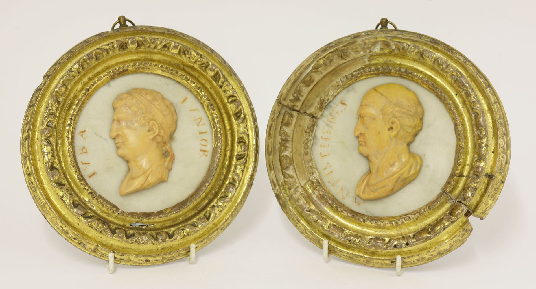 A pair of circular Grand Tour plaques,18th century, each a carved relief bust in yellow marble,