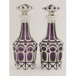 A pair of Bohemian overlaid purple glass decanters and stoppers,with enamel decoration,28cm high,