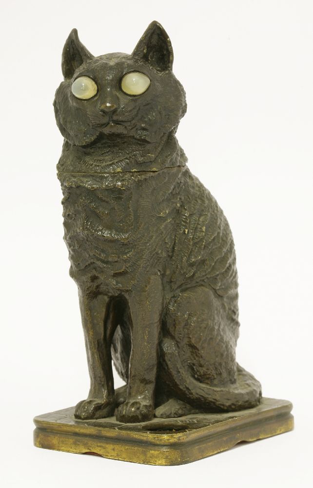 A bronze inkwell,late 19th century, modelled as a seated cat with hinged head and glass eyes,23cm