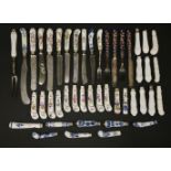 A collection of pottery and porcelain knife and fork handles,mainly 19th century, with blue and