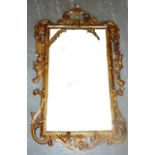 A rococo style gilt framed wall hanging Looking Glass, the pierced pediment with 'C' scrolls,