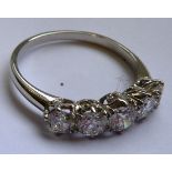 A very fine quality ladies platinum Ring mounted with a band of five very fine diamonds (total