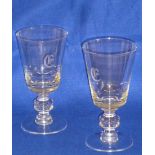 A large pair of conical shaped clear glass Wines, each engraved with a lower case Gothic style 'ε',