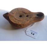 A Roman style red terracotta Oil Lamp of predominantly circular section,