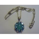 A 9 carat white gold diamond and aquamarine Cluster Pendant with central oval cabouchon blue stone